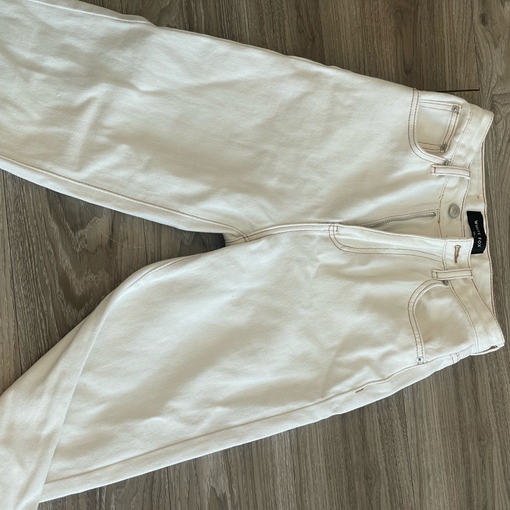 white pants with brown stitching